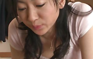 Japanese unlighted slutwife Emiko Koike enjoys engulfing cock uncensored.